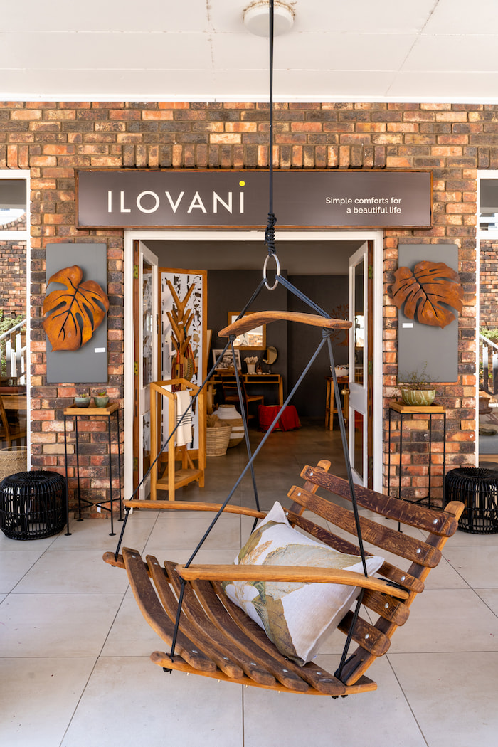 a picture of the ilovani shop front with signage and hanging chair